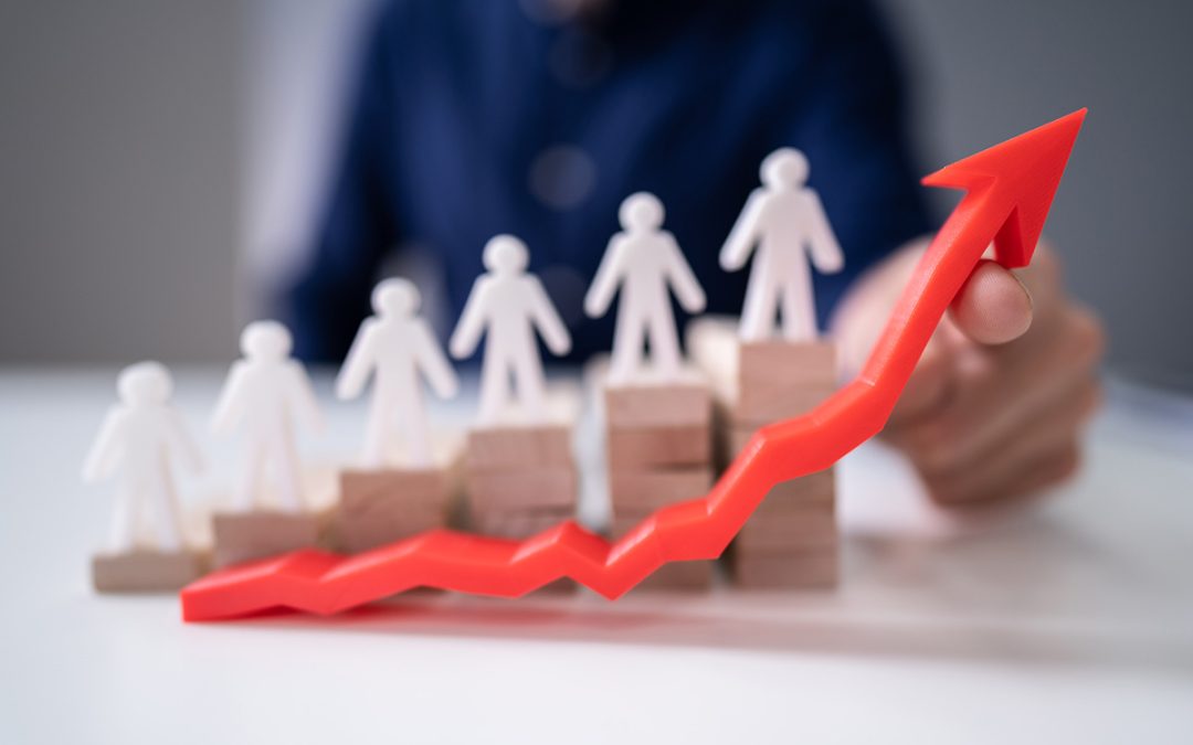 Businessperson's Hand Holding Red Arrow